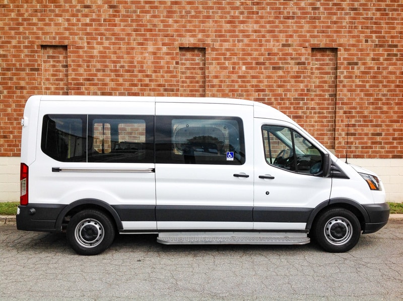  Side view of white Ford Paratransit Wheelchair Van.