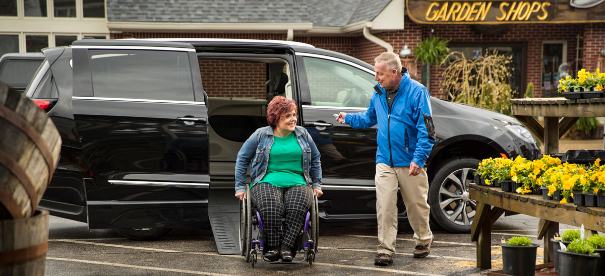 couple infront wheelchair van